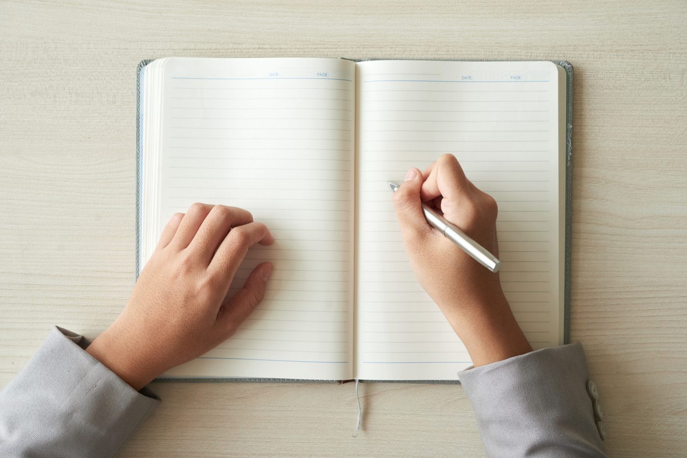 An author writing in a notebook